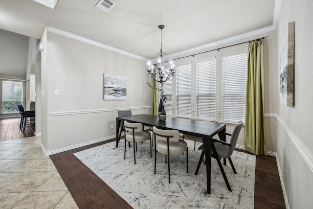 9721 Stripling Dr, Fort Worth, TX 76244 - dining space featuring a chandelier, crown molding, wood finished floors, and baseboards