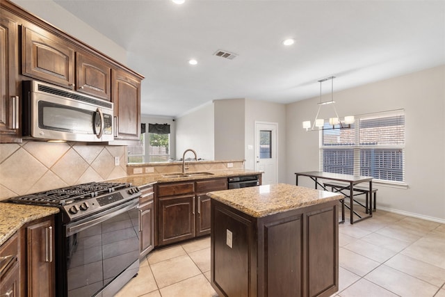 5532 Grayson Ridge Dr, Fort Worth, TX 76179 - kitchen with stainless steel appliances, backsplash, light tile patterned flooring, recessed lighting, and decorative light fixtures