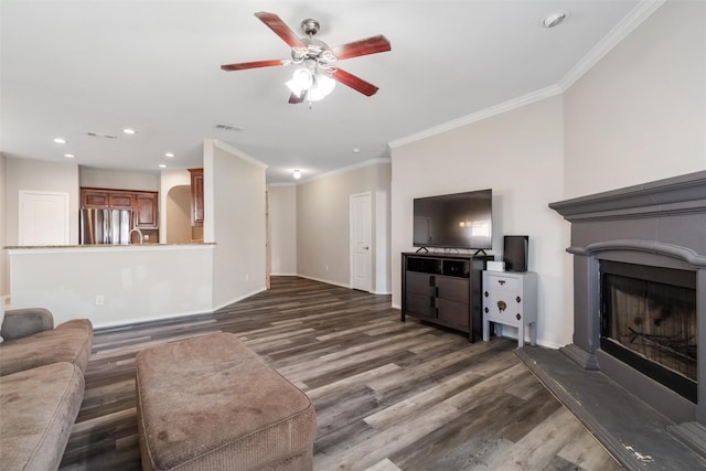 5532 Grayson Ridge Dr, Fort Worth, TX 76179 - unfurnished living room featuring dark wood-style floors, ceiling fan, recessed lighting, a fireplace with raised hearth, and ornamental molding