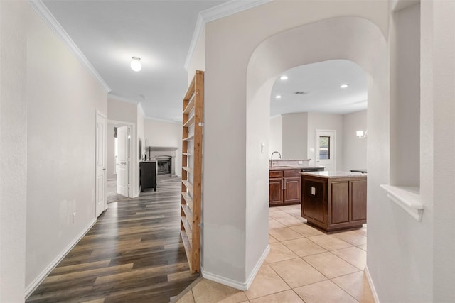 5532 Grayson Ridge Dr, Fort Worth, TX 76179 - hallway with crown molding, arched walkways, light tile patterned floors, and recessed lighting