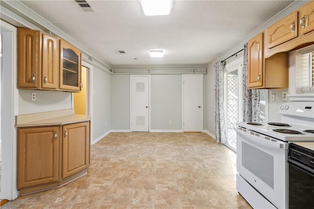 kitchen featuring light countertops, visible vents, baseboards, glass insert cabinets, and electric range