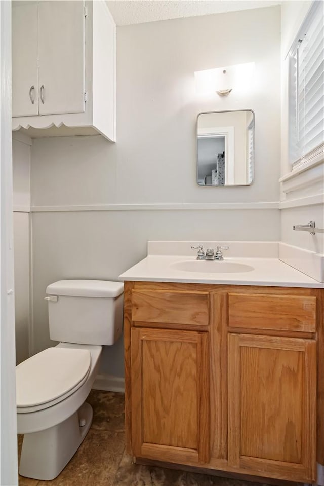 bathroom featuring toilet and vanity