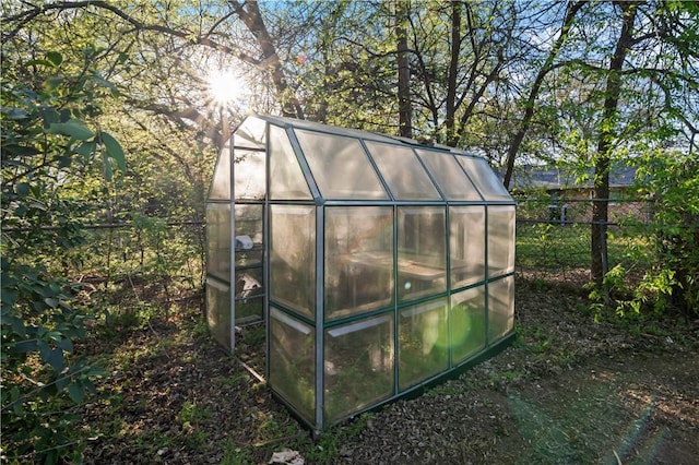 view of greenhouse featuring fence
