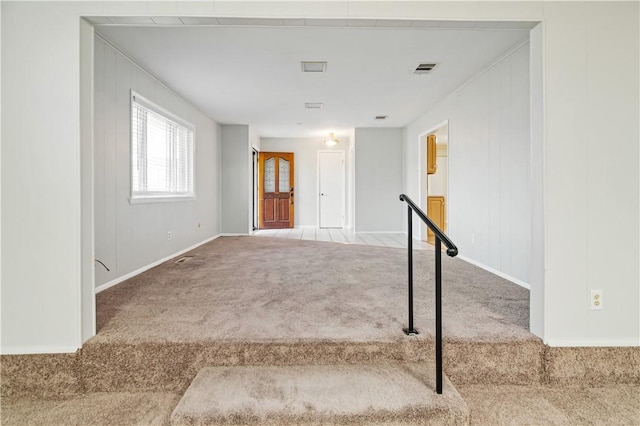 interior space with baseboards, visible vents, and carpet