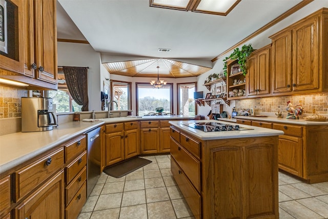 kitchen featuring a sink, backsplash, and brown cabinets