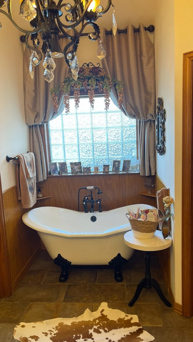 1752 County Road 1450, Bonham, TX 75418 - bathroom featuring a soaking tub and wainscoting