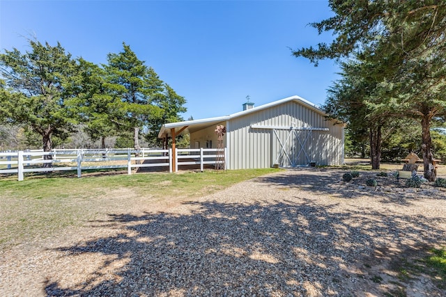 exterior space featuring fence and an outdoor structure