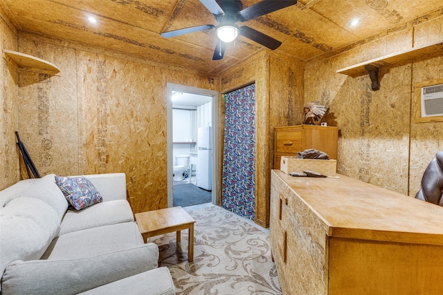 interior space featuring ceiling fan, an AC wall unit, and light colored carpet