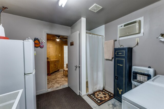 laundry room featuring laundry area, a ceiling fan, visible vents, heating unit, and carpet flooring