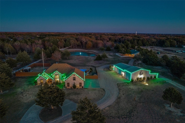 drone / aerial view featuring a wooded view