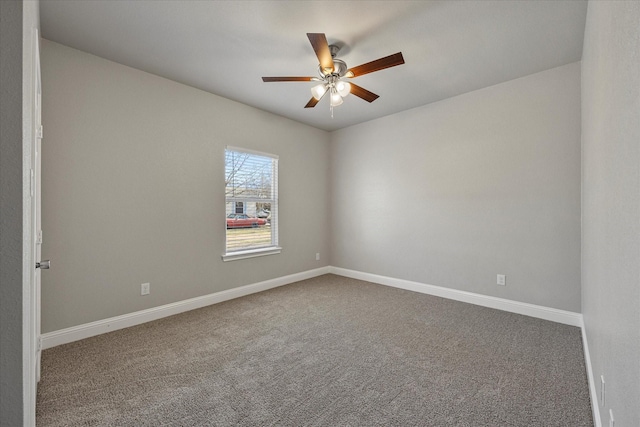 spare room featuring baseboards, carpet flooring, and a ceiling fan