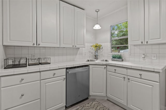 kitchen featuring a sink, dishwasher, and white cabinets
