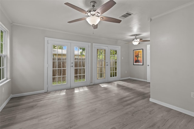 unfurnished room featuring visible vents, baseboards, french doors, and plenty of natural light