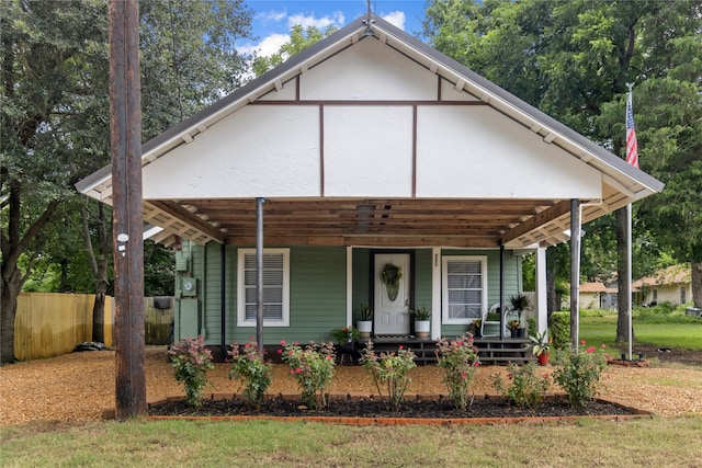 view of front of property featuring a porch and fence