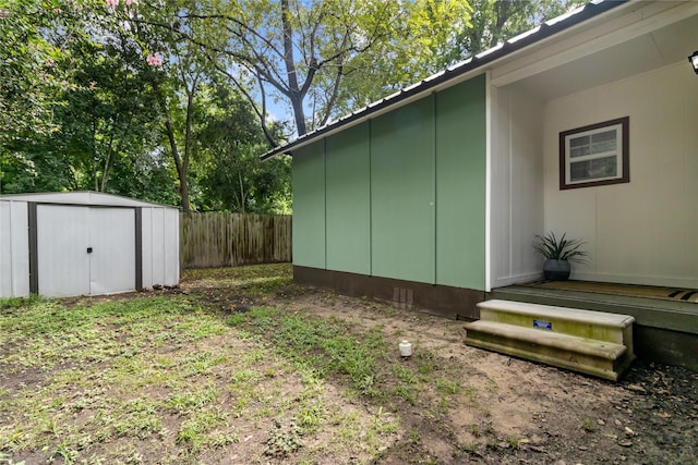 view of home's exterior featuring an outdoor structure, a storage shed, and fence