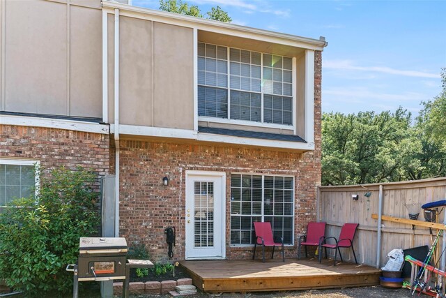 2411 Northlake Ct, Irving, TX 75038 - rear view of house with fence, brick siding, and a deck