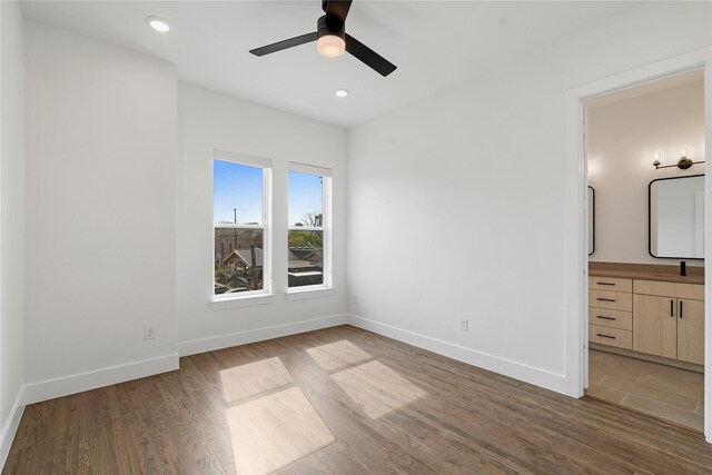 1804 Ripley St Unit 105, Dallas, TX 75204 - unfurnished bedroom with baseboards, wood finished floors, recessed lighting, ensuite bath, and a ceiling fan