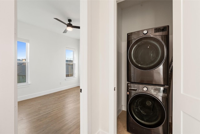 1804 Ripley St Unit 105, Dallas, TX 75204 - laundry area featuring stacked washer and clothes dryer, wood finished floors, baseboards, and a ceiling fan