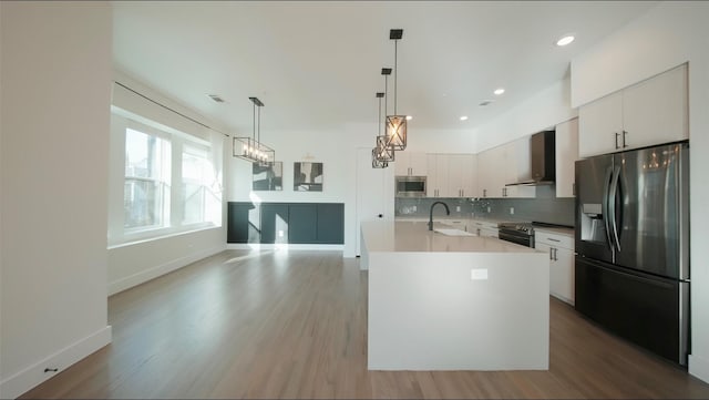1804 Ripley St Unit 105, Dallas, TX 75204 - kitchen with stainless steel appliances, wall chimney range hood, light wood finished floors, backsplash, and recessed lighting