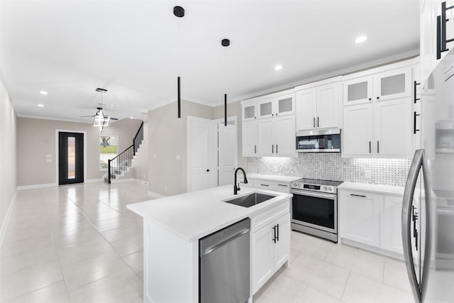 2111 Brookhaven Dr, Dallas, TX 75224 - kitchen featuring light countertops, a sink, stainless steel appliances, and tasteful backsplash