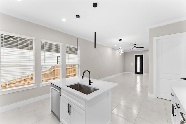 2111 Brookhaven Dr, Dallas, TX 75224 - kitchen with light countertops, stainless steel dishwasher, hanging light fixtures, a sink, and a center island with sink