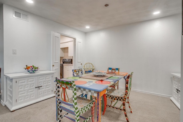 dining area featuring light carpet, baseboards, visible vents, and recessed lighting