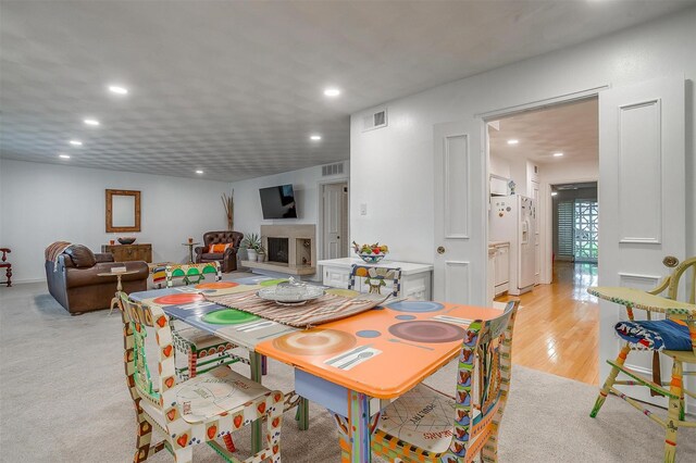 dining space with visible vents, light wood-style flooring, and recessed lighting