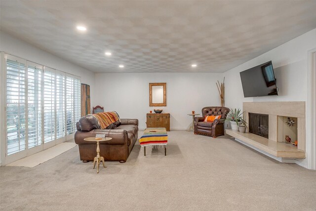 living room with a high end fireplace, carpet floors, and recessed lighting