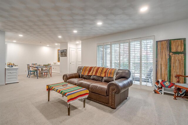 carpeted living area with recessed lighting