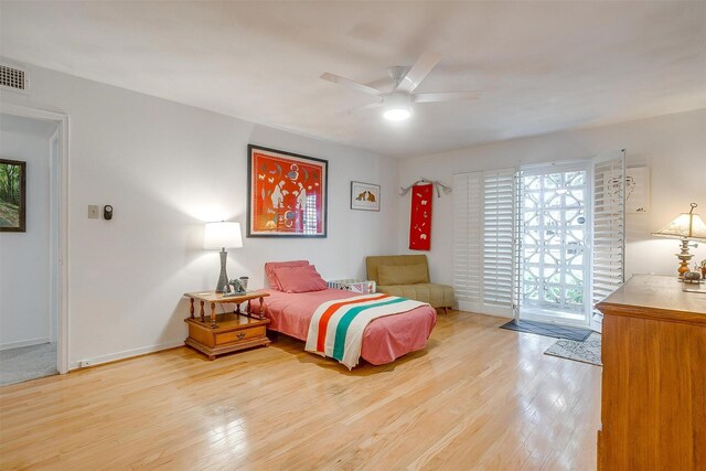 bedroom featuring baseboards, access to exterior, wood finished floors, and a ceiling fan