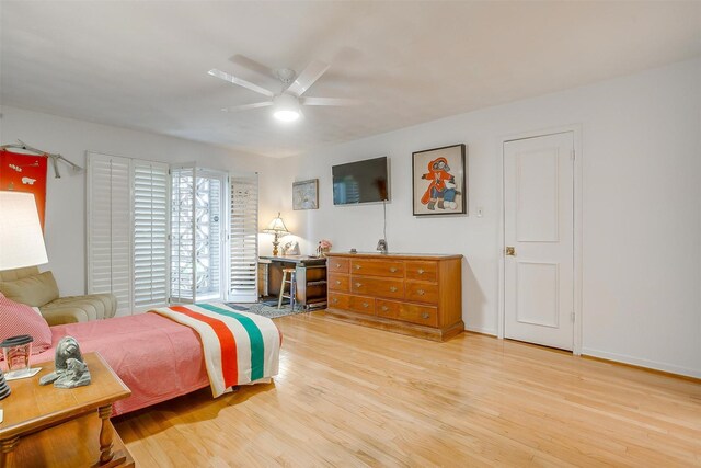 bedroom with baseboards, wood finished floors, and a ceiling fan