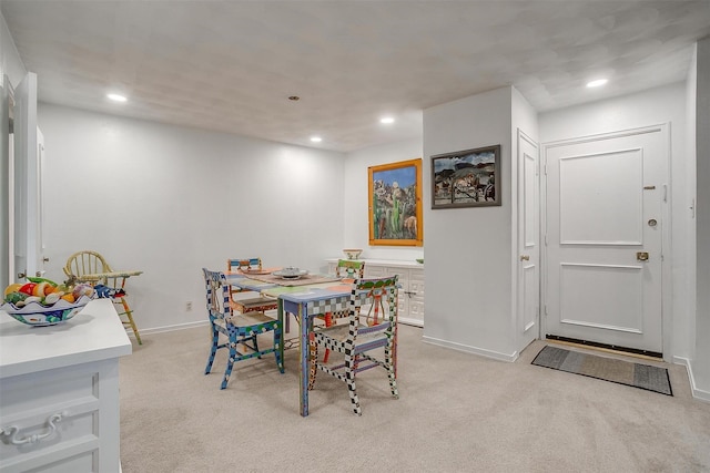 dining room with light carpet and recessed lighting