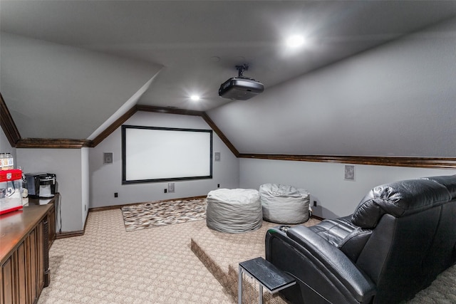 cinema room with light carpet, baseboards, and lofted ceiling