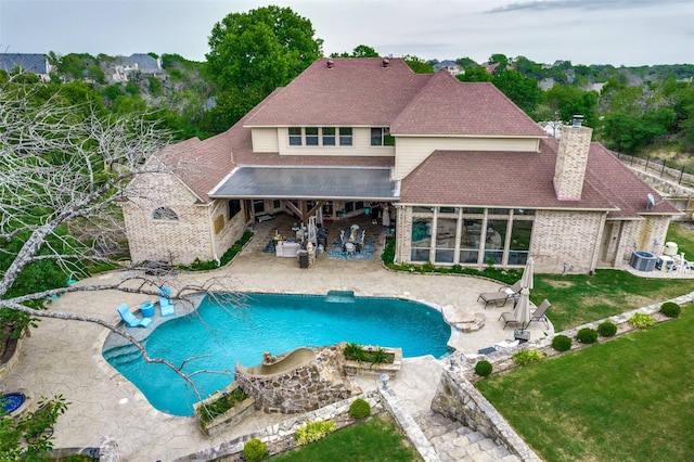 swimming pool featuring a patio area and cooling unit