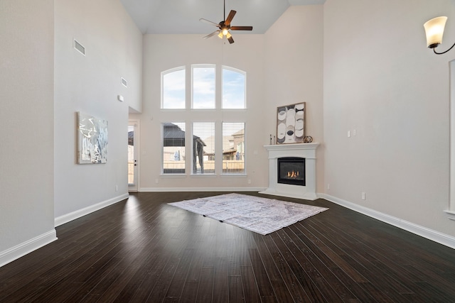 15664 Wild Cherry Ln, Fort Worth, TX 76262 - living room with high vaulted ceiling, a ceiling fan, a glass covered fireplace, dark wood finished floors, and baseboards