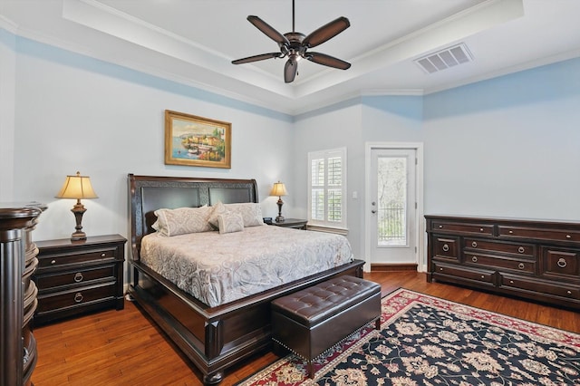 3713 Hidden Trl, Flower Mound, TX 75022 - bedroom featuring a tray ceiling, access to exterior, dark wood-type flooring, ornamental molding, and ceiling fan