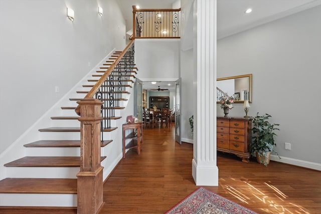 3713 Hidden Trl, Flower Mound, TX 75022 - stairs with a towering ceiling, wood finished floors, ornate columns, and recessed lighting
