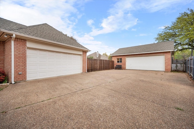 detached garage featuring fence