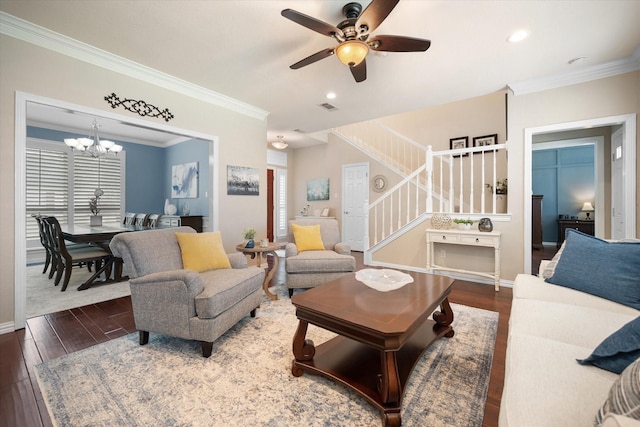 living area featuring stairway, crown molding, wood finished floors, ceiling fan with notable chandelier, and visible vents