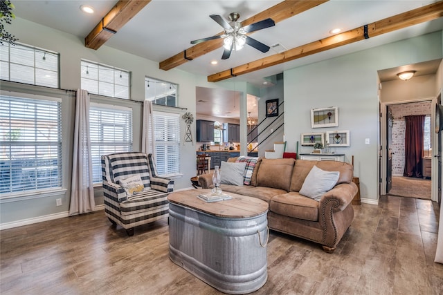 living room featuring a ceiling fan, dark wood-type flooring, baseboards, and beamed ceiling