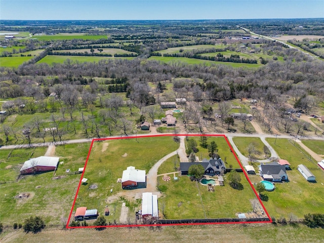 birds eye view of property with a rural view