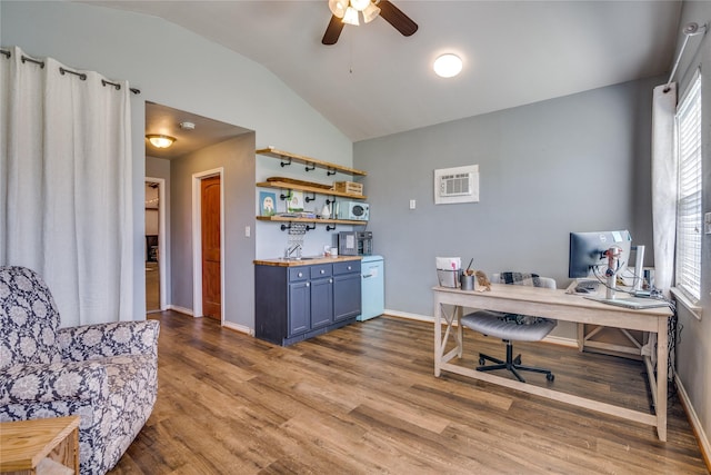 home office with baseboards, vaulted ceiling, wood finished floors, and ceiling fan