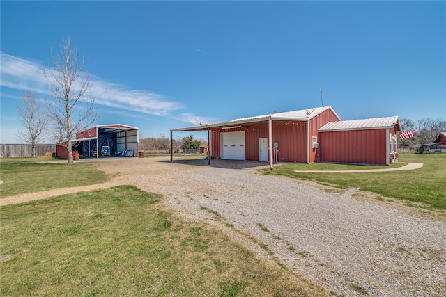 view of pole building featuring gravel driveway and a yard