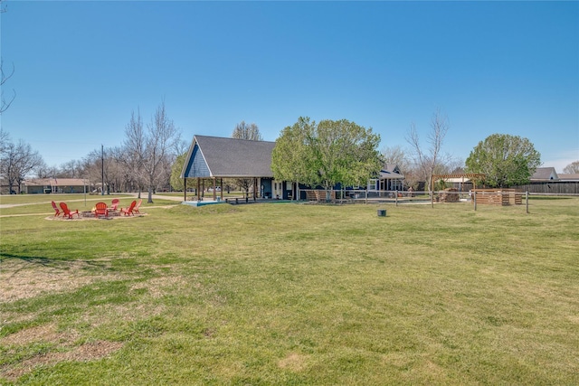 view of yard featuring a fire pit, a gazebo, and fence