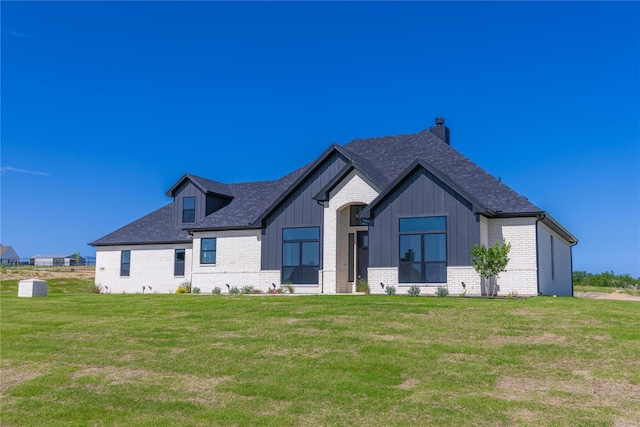 145 Quail Ridge Ct, Decatur, TX 76234 - view of front of home with brick siding, a front lawn, roof with shingles, and board and batten siding