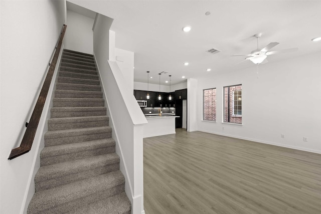 2412 Bulin Dr, Mansfield, TX 76063 - stairway with recessed lighting, wood finished floors, ceiling fan, and baseboards