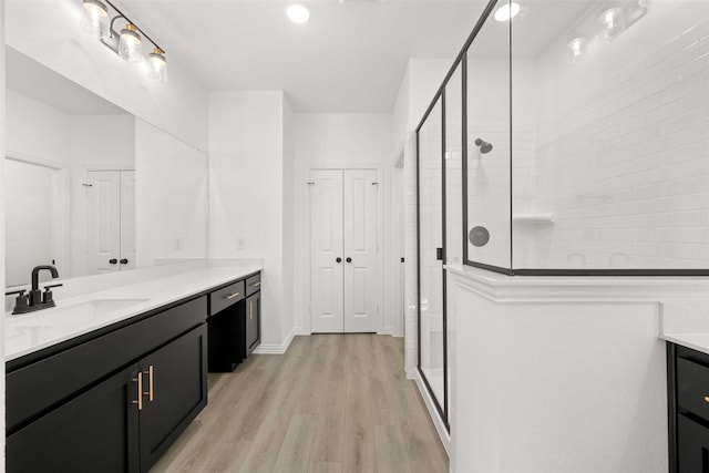 2412 Bulin Dr, Mansfield, TX 76063 - bathroom featuring vanity, a stall shower, wood finished floors, and recessed lighting