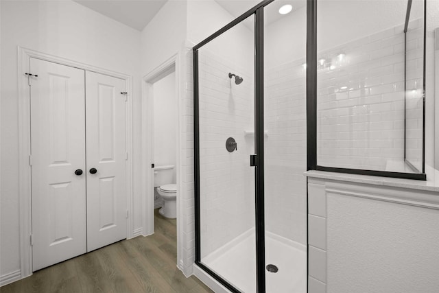 2412 Bulin Dr, Mansfield, TX 76063 - bathroom with wood finished floors, toilet, and a stall shower