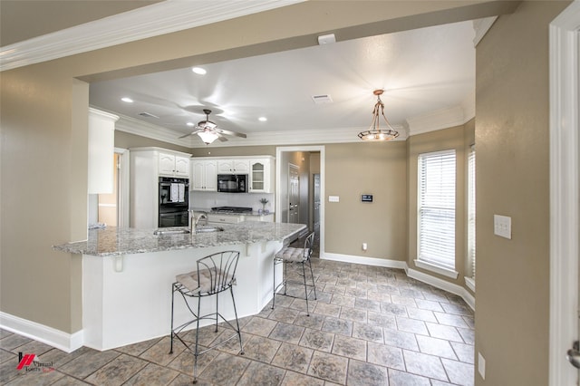339 Hunters Holw, Bossier City, LA 71111 - kitchen with white cabinetry, a kitchen bar, crown molding, a peninsula, and black appliances