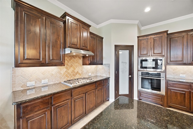 216 Equestrian Rd, Hickory Creek, TX 75065 - kitchen featuring stainless steel appliances, under cabinet range hood, dark stone countertops, backsplash, and dark brown cabinets